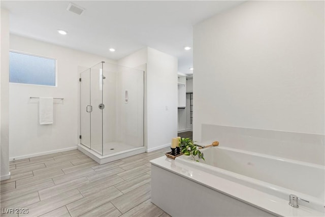 6234 Amber View St, Las Vegas, NV 89135 - full bathroom featuring a stall shower, a garden tub, wood finish floors, and recessed lighting