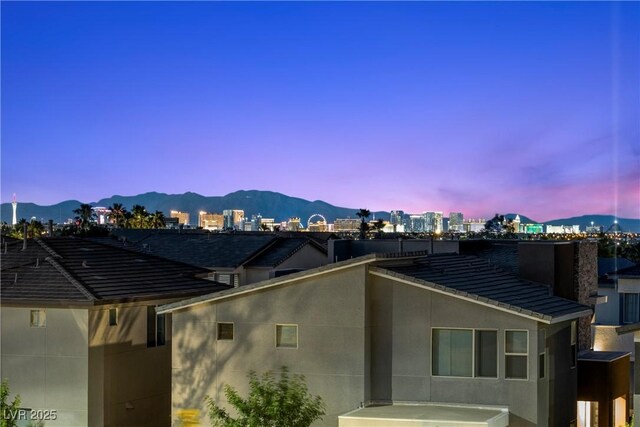 6234 Amber View St, Las Vegas, NV 89135 - property exterior at dusk featuring a mountain view and a city view