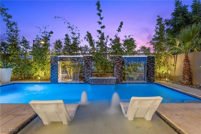 6234 Amber View St, Las Vegas, NV 89135 - pool at dusk with a fenced backyard