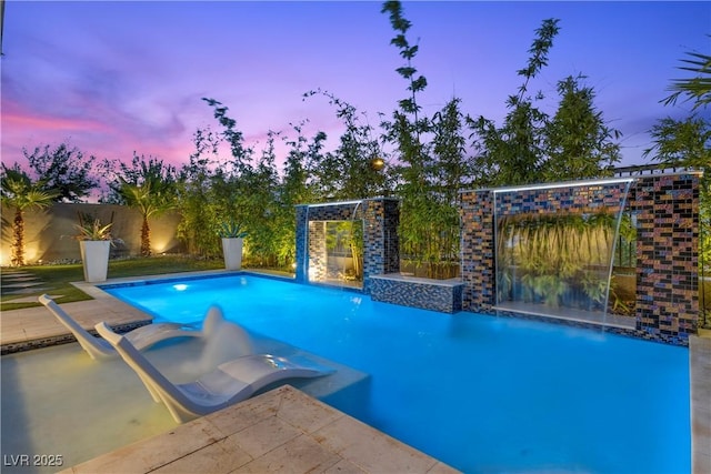 6234 Amber View St, Las Vegas, NV 89135 - pool at dusk featuring a fenced backyard
