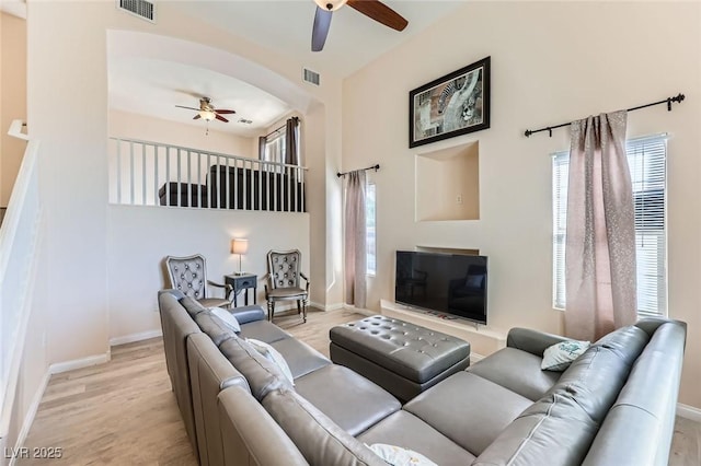 2792 Fountain Ridge Ln, Henderson, NV 89074 - living room featuring a ceiling fan, light wood-type flooring, and arched walkways