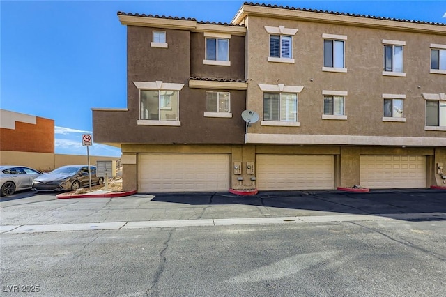 2792 Fountain Ridge Ln, Henderson, NV 89074 - view of front of property with stucco siding, an attached garage, and a tiled roof