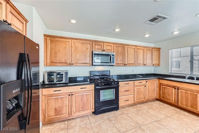 2792 Fountain Ridge Ln, Henderson, NV 89074 - kitchen with black appliances, recessed lighting, and light tile patterned floors