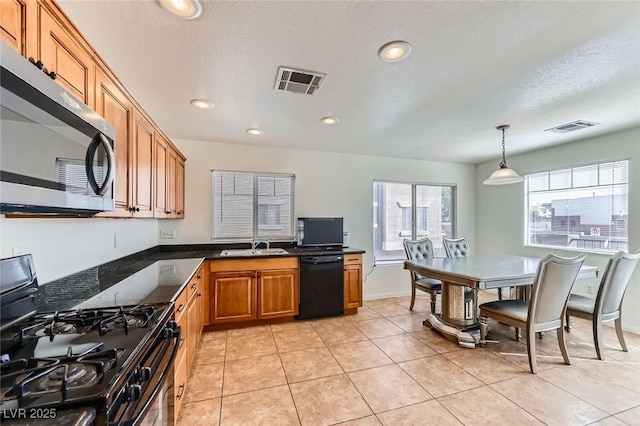 2792 Fountain Ridge Ln, Henderson, NV 89074 - kitchen featuring black appliances, brown cabinetry, dark countertops, pendant lighting, and recessed lighting