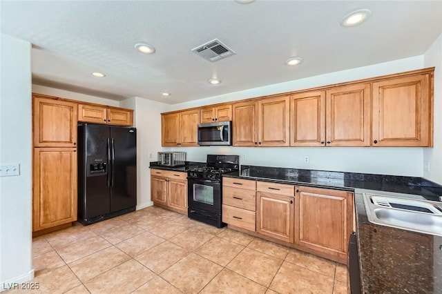 2792 Fountain Ridge Ln, Henderson, NV 89074 - kitchen with black appliances, recessed lighting, light tile patterned floors, brown cabinets, and dark stone countertops