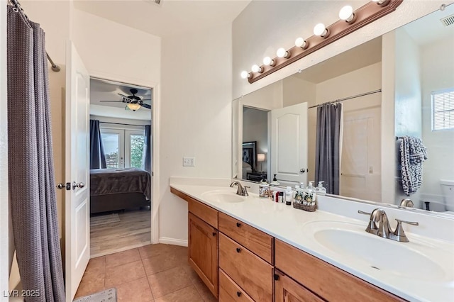 2792 Fountain Ridge Ln, Henderson, NV 89074 - ensuite bathroom with double vanity, tile patterned flooring, curtained shower, and a ceiling fan