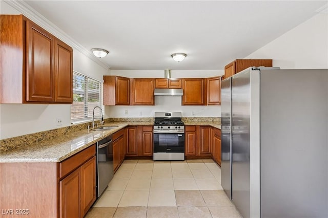 7000 Paddington Way, Las Vegas, NV 89147 - kitchen with appliances with stainless steel finishes, under cabinet range hood, light stone counters, brown cabinets, and light tile patterned flooring
