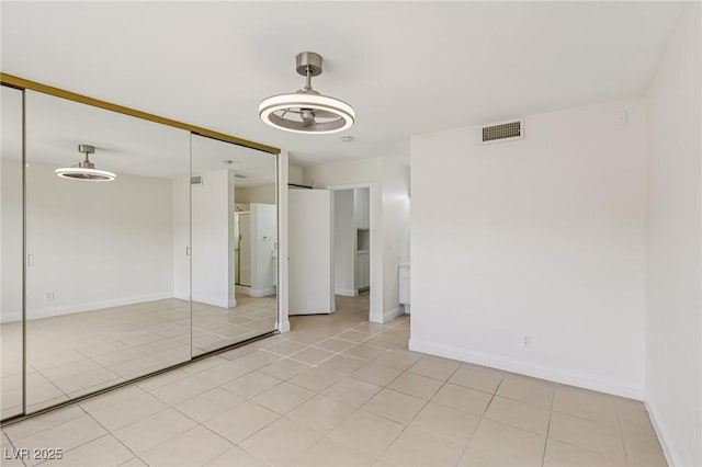 7000 Paddington Way, Las Vegas, NV 89147 - unfurnished bedroom with a closet and light tile patterned flooring