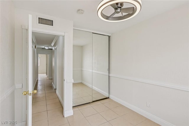 7000 Paddington Way, Las Vegas, NV 89147 - unfurnished bedroom with light tile patterned floors, a closet, attic access, and a ceiling fan