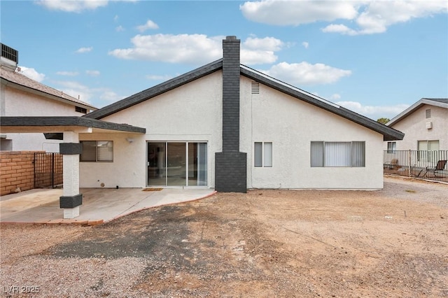 7000 Paddington Way, Las Vegas, NV 89147 - back of property featuring a patio, stucco siding, and a chimney