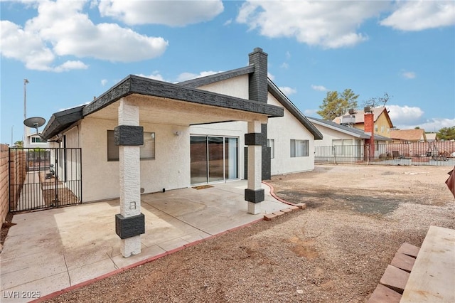 7000 Paddington Way, Las Vegas, NV 89147 - back of property featuring a fenced backyard, stucco siding, and a patio area