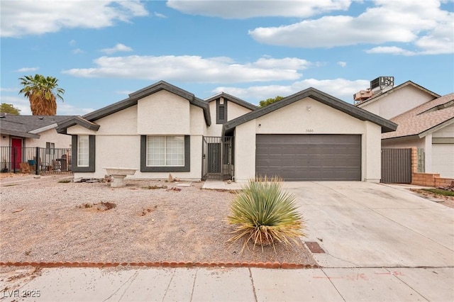 7000 Paddington Way, Las Vegas, NV 89147 - view of front of house featuring a garage, driveway, stucco siding, and a gate