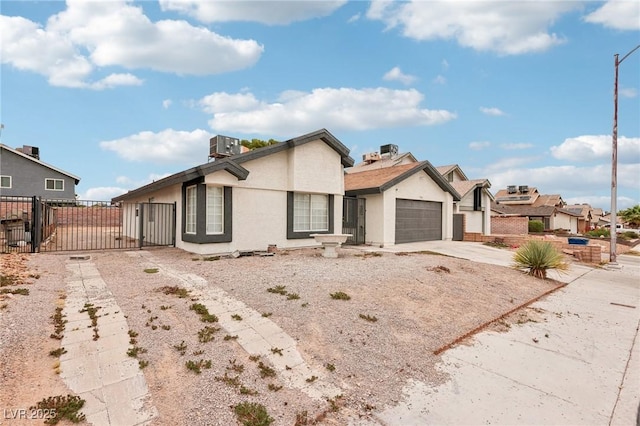 7000 Paddington Way, Las Vegas, NV 89147 - view of front facade featuring a gate, concrete driveway, a residential view, stucco siding, and a garage