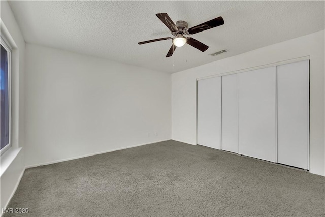 1676 Divinity St, Las Vegas, NV 89142 - unfurnished bedroom featuring carpet floors, a textured ceiling, a closet, and ceiling fan