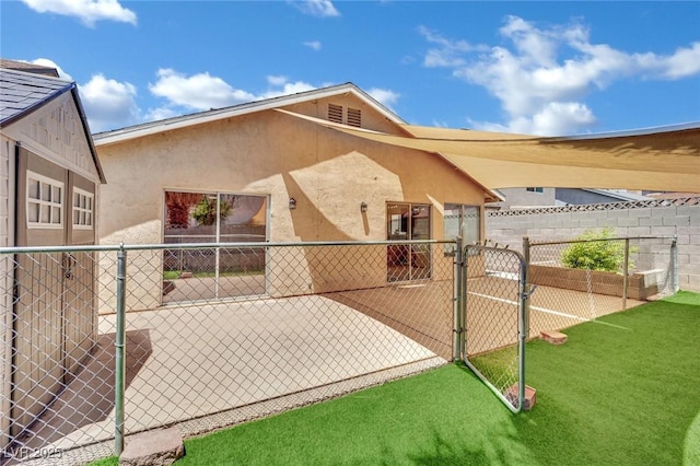 1676 Divinity St, Las Vegas, NV 89142 - back of house with a gate, stucco siding, and a patio area