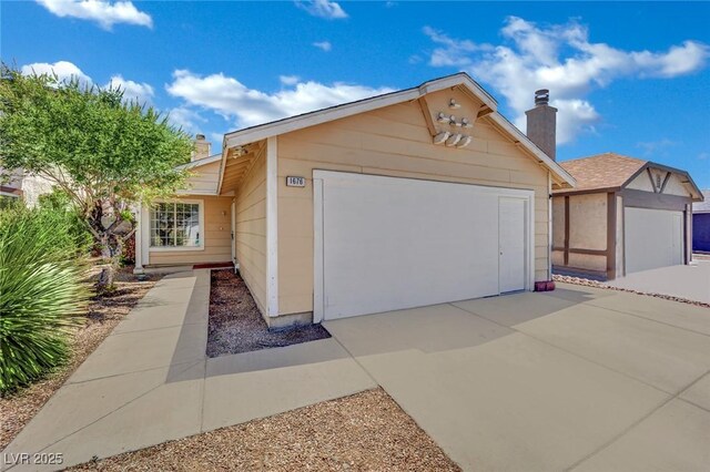 1676 Divinity St, Las Vegas, NV 89142 - ranch-style house featuring a chimney, a garage, and concrete driveway