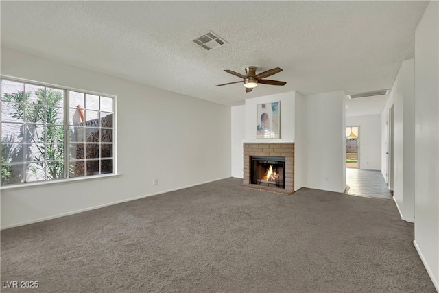 1676 Divinity St, Las Vegas, NV 89142 - unfurnished living room featuring carpet flooring, a brick fireplace, a textured ceiling, and a ceiling fan