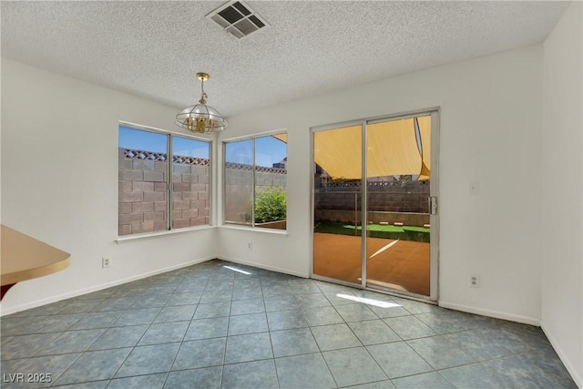 1676 Divinity St, Las Vegas, NV 89142 - empty room with a chandelier, tile patterned flooring, and a textured ceiling