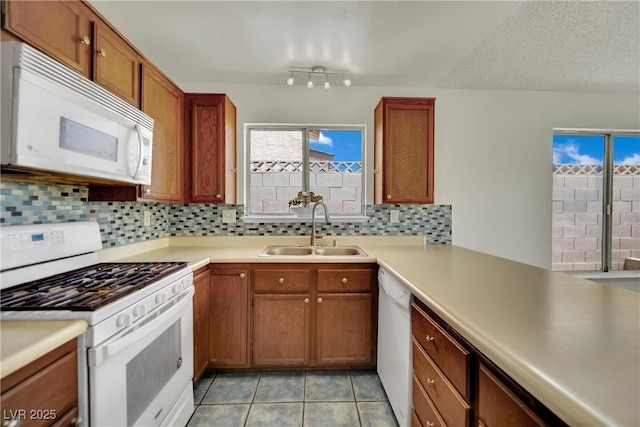 1676 Divinity St, Las Vegas, NV 89142 - kitchen featuring white appliances, decorative backsplash, and light countertops