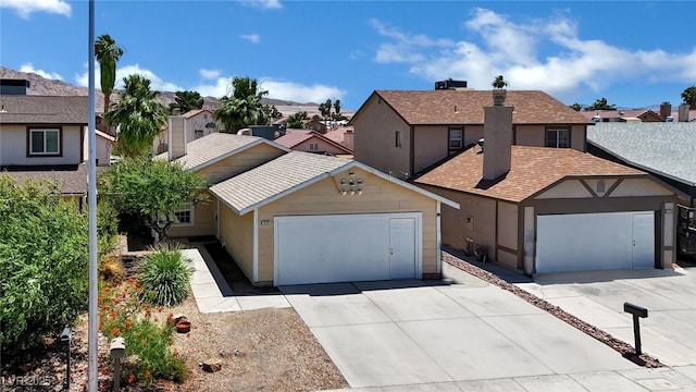 1676 Divinity St, Las Vegas, NV 89142 - view of front of property featuring driveway, a garage, a residential view, a chimney, and roof with shingles
