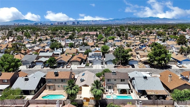 1676 Divinity St, Las Vegas, NV 89142 - aerial perspective of suburban area featuring a pool area and a mountain backdrop