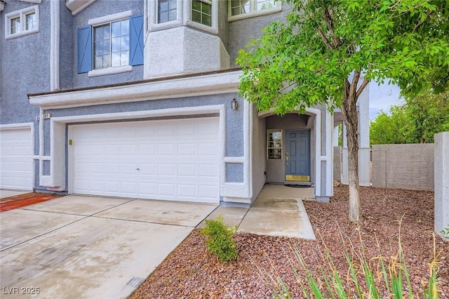 247 Integrity Ridge Dr, Henderson, NV 89052 - doorway to property featuring stucco siding, an attached garage, and driveway