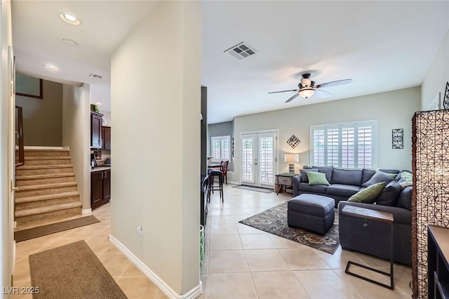 247 Integrity Ridge Dr, Henderson, NV 89052 - living room featuring light tile patterned flooring, a ceiling fan, stairway, recessed lighting, and french doors