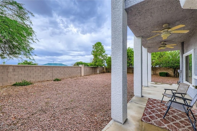 247 Integrity Ridge Dr, Henderson, NV 89052 - fenced backyard with ceiling fan and a patio area