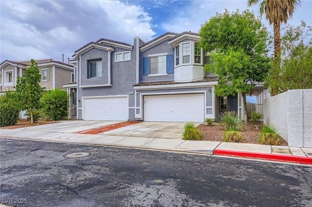 247 Integrity Ridge Dr, Henderson, NV 89052 - view of front of property featuring a garage, concrete driveway, stucco siding, and a tile roof
