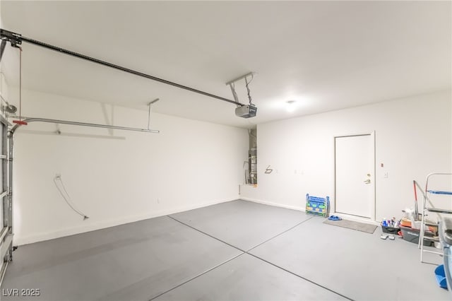 3844 Kit Fox St, Las Vegas, NV 89122 - garage with a garage door opener and baseboards