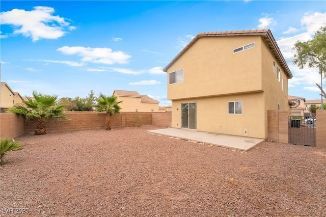 3844 Kit Fox St, Las Vegas, NV 89122 - rear view of house featuring a patio, stucco siding, and a fenced backyard