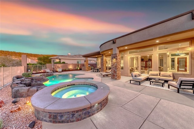 22 Starbrook Dr, Henderson, NV 89052 - pool at dusk with an in-ground hot tub, a patio, outdoor lounge area, and a fenced backyard