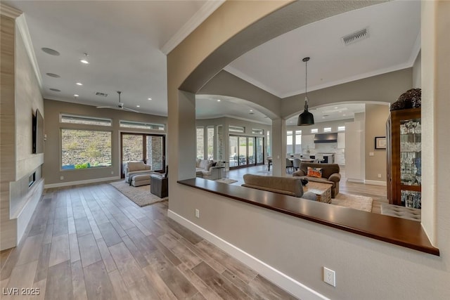 22 Starbrook Dr, Henderson, NV 89052 - kitchen with a fireplace, ceiling fan, open floor plan, crown molding, and recessed lighting