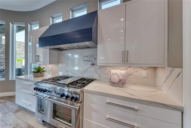 22 Starbrook Dr, Henderson, NV 89052 - kitchen featuring range with two ovens, custom exhaust hood, and modern cabinets