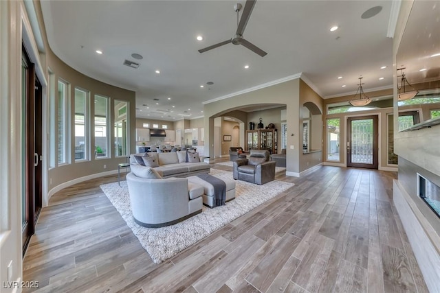 22 Starbrook Dr, Henderson, NV 89052 - living room with arched walkways, a ceiling fan, recessed lighting, healthy amount of natural light, and ornamental molding
