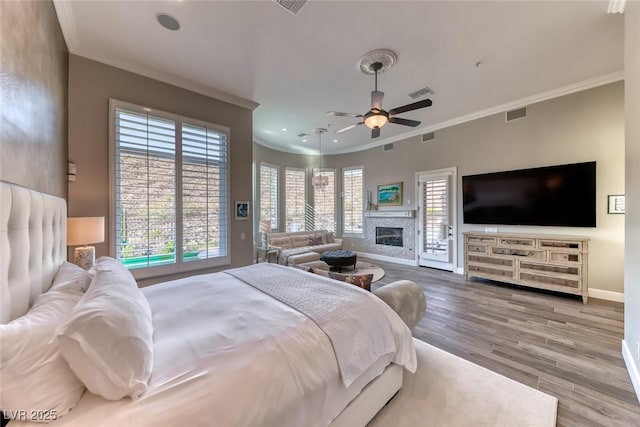 22 Starbrook Dr, Henderson, NV 89052 - bedroom featuring ornamental molding, access to exterior, wood finished floors, a glass covered fireplace, and recessed lighting