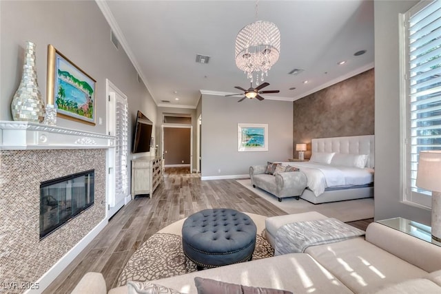 22 Starbrook Dr, Henderson, NV 89052 - bedroom with a chandelier, ornamental molding, light wood-style flooring, a glass covered fireplace, and recessed lighting