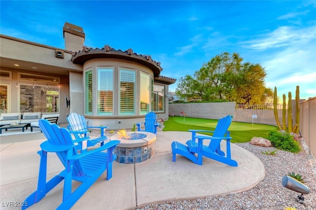 22 Starbrook Dr, Henderson, NV 89052 - fenced backyard with a putting green, a patio, and an outdoor fire pit