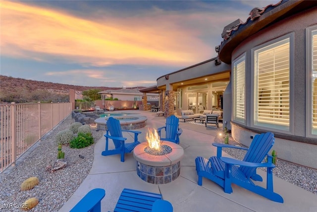 22 Starbrook Dr, Henderson, NV 89052 - fenced backyard featuring a patio, an outdoor living space with a fire pit, and a pool with connected hot tub