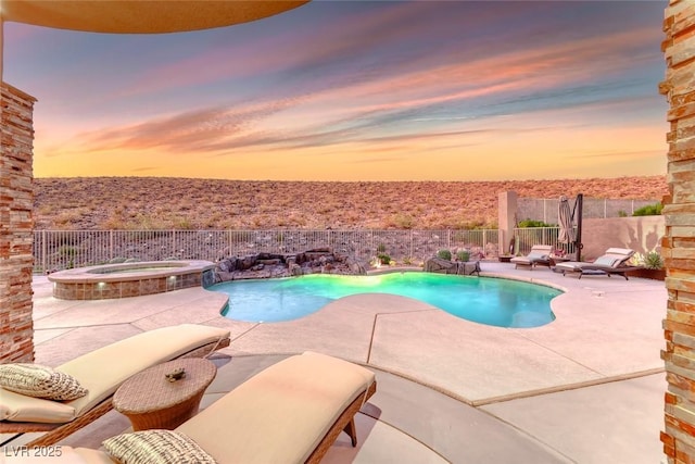 22 Starbrook Dr, Henderson, NV 89052 - pool at dusk featuring a fenced backyard, a patio, and a pool with connected hot tub