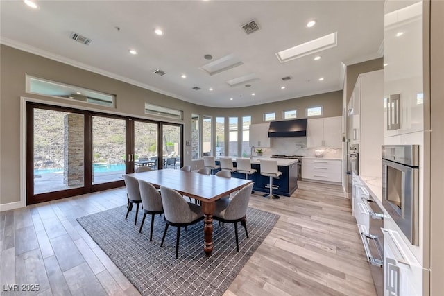 22 Starbrook Dr, Henderson, NV 89052 - dining area with ornamental molding, french doors, light wood-style flooring, and recessed lighting