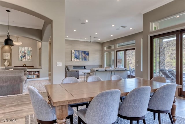 22 Starbrook Dr, Henderson, NV 89052 - dining room with recessed lighting, light wood-style flooring, and arched walkways