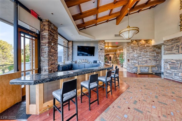22 Starbrook Dr, Henderson, NV 89052 - indoor wet bar featuring high vaulted ceiling, beamed ceiling, wood finished floors, and pendant lighting