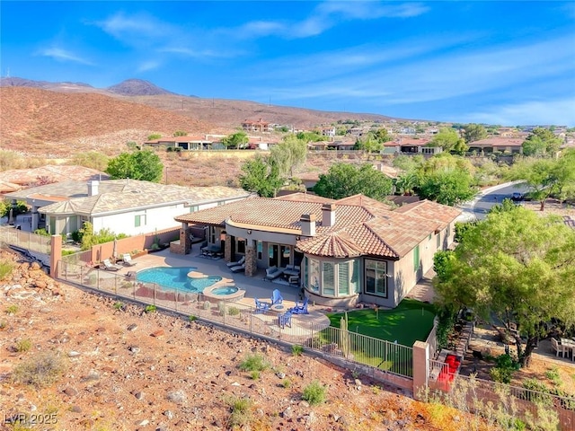 22 Starbrook Dr, Henderson, NV 89052 - rear view of house featuring a fenced backyard, a patio area, a tile roof, and a mountain view