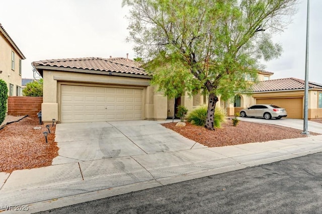 6720 Sand Swallow St, North Las Vegas, NV 89084 - mediterranean / spanish house featuring driveway, stucco siding, a tile roof, and a garage