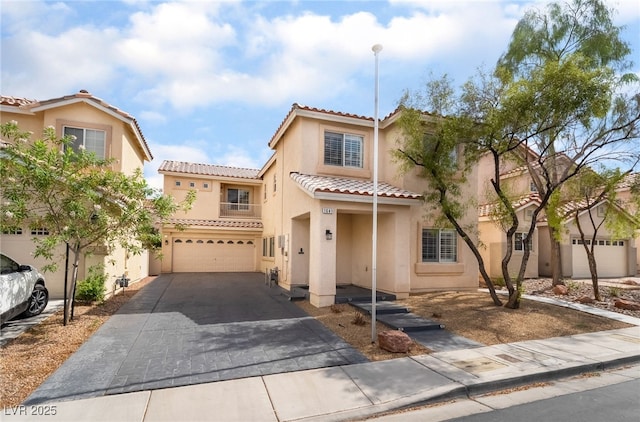 1641 Dark Wolf Ave, Las Vegas, NV 89123 - mediterranean / spanish home with an attached garage, driveway, a tile roof, and stucco siding