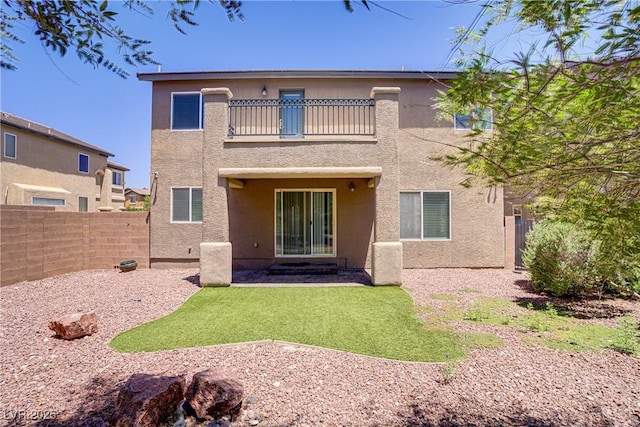 10015 Willowbrook Pond Rd, Las Vegas, NV 89148 - rear view of property with a balcony, stucco siding, and a fenced backyard