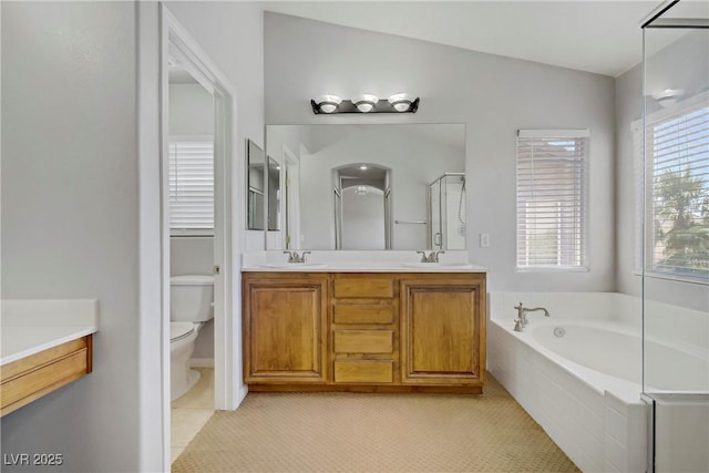 10015 Willowbrook Pond Rd, Las Vegas, NV 89148 - full bathroom featuring double vanity, a garden tub, tile patterned floors, and a shower with door
