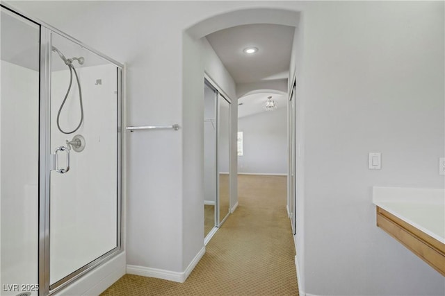 10015 Willowbrook Pond Rd, Las Vegas, NV 89148 - hallway with arched walkways, light colored carpet, and recessed lighting