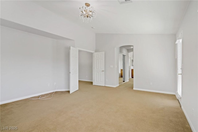 10015 Willowbrook Pond Rd, Las Vegas, NV 89148 - unfurnished room featuring arched walkways, lofted ceiling, and light colored carpet